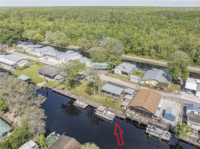 birds eye view of property with a residential view, a forest view, and a water view