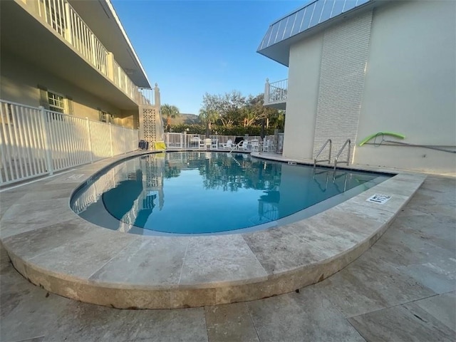 community pool featuring fence private yard and a patio area