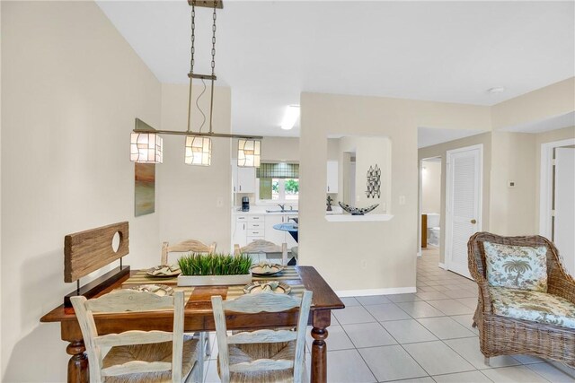 5040 Harmony Cir Unit 205, Vero Beach, FL 32967 - dining space with light tile patterned floors and baseboards
