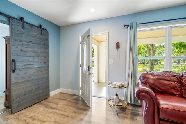 1717 20th Ave, Vero Beach, FL 32960 - entryway with plenty of natural light, light wood-style floors, a barn door, and recessed lighting