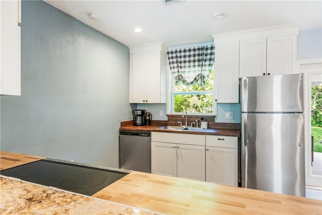 1717 20th Ave, Vero Beach, FL 32960 - kitchen with appliances with stainless steel finishes, butcher block countertops, white cabinets, and recessed lighting
