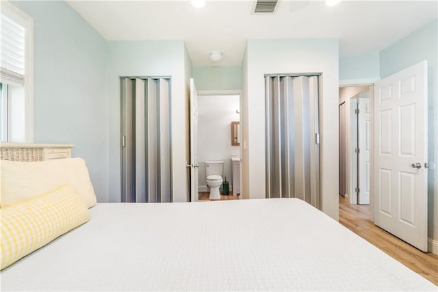 1717 20th Ave, Vero Beach, FL 32960 - bedroom featuring multiple closets, light wood-type flooring, recessed lighting, and ensuite bathroom