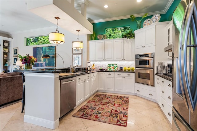 kitchen featuring white cabinets, stainless steel appliances, and crown molding