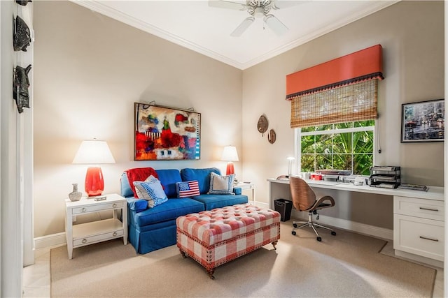 carpeted office featuring ceiling fan, built in desk, and crown molding