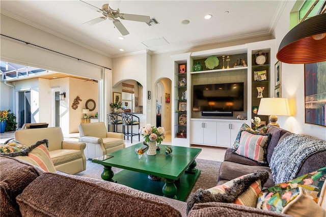 living room featuring crown molding and ceiling fan