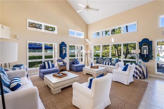 living room featuring light tile patterned flooring, a towering ceiling, and a wealth of natural light