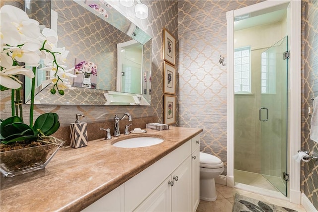 bathroom featuring tile patterned floors, vanity, toilet, and an enclosed shower