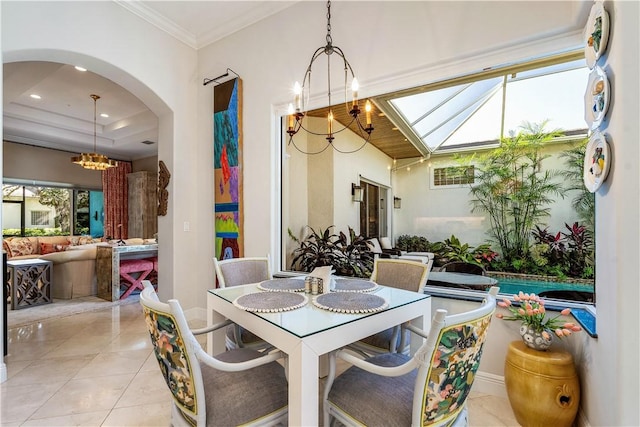 dining area featuring light tile patterned floors, a chandelier, and ornamental molding