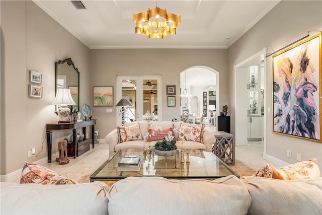 living room with light tile patterned flooring, ornamental molding, and an inviting chandelier