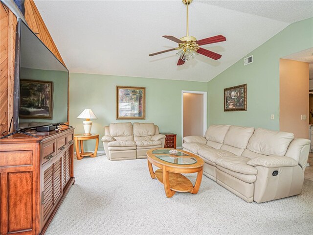 living room featuring light colored carpet, ceiling fan, and vaulted ceiling