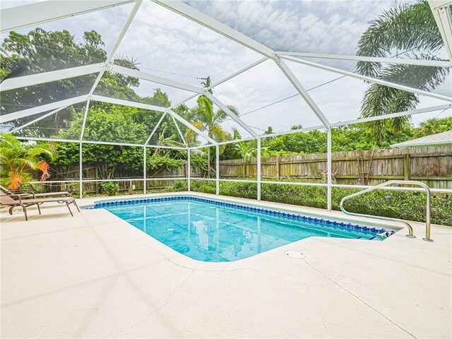 view of pool with a lanai and a patio area