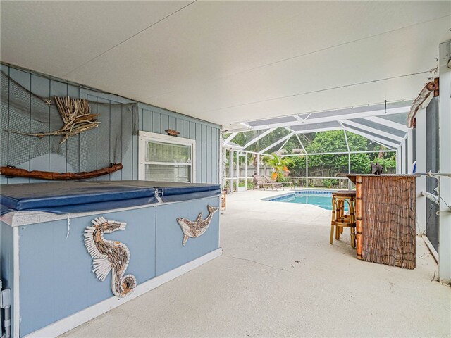 view of pool featuring a lanai, a patio, and a hot tub