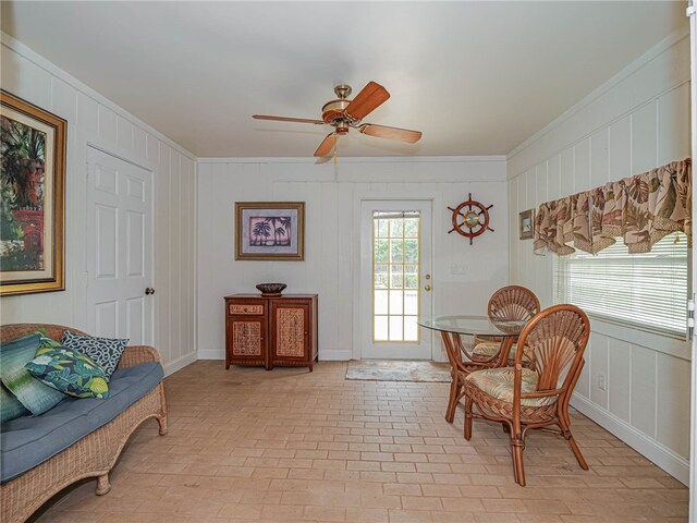 living area featuring ceiling fan and ornamental molding