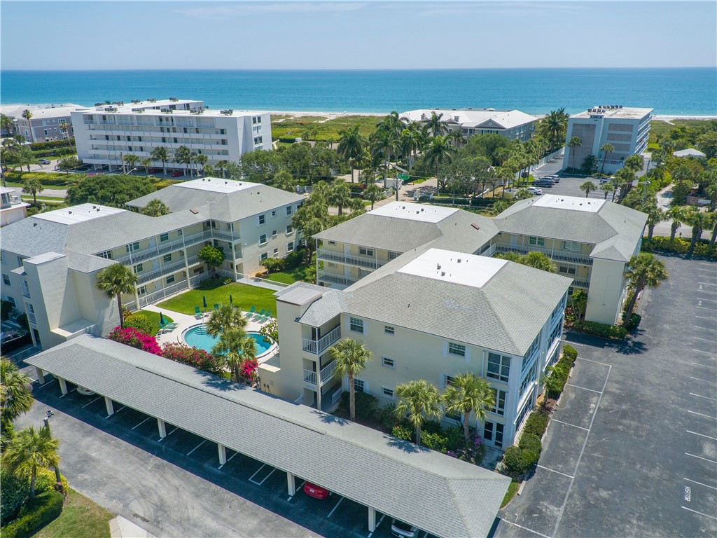 1441 Ocean Dr Unit 109, Vero Beach, FL 32963 - aerial view of a nearby body of water and a pool area