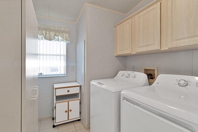 laundry room featuring separate washer and dryer, cabinets, ornamental molding, and light tile patterned floors