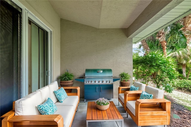 view of patio with area for grilling, outdoor lounge area, and exterior kitchen