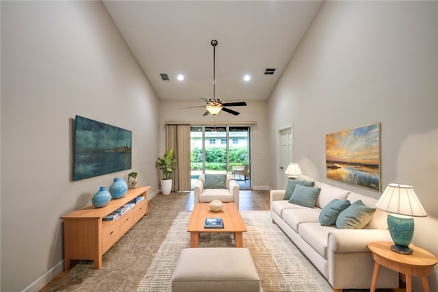 living room featuring ceiling fan and high vaulted ceiling