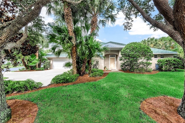 view of front of home with a garage and a front lawn