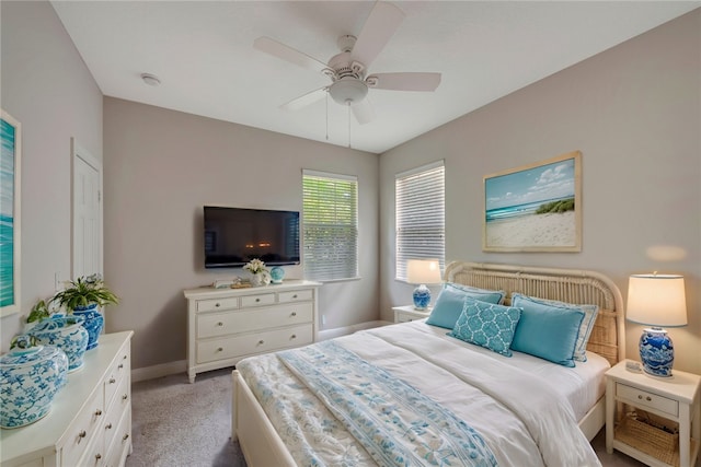 bedroom with light colored carpet and ceiling fan