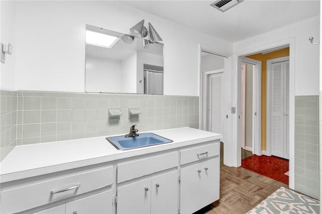 bathroom with vanity and parquet flooring