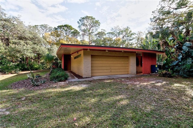 garage with a carport and a yard