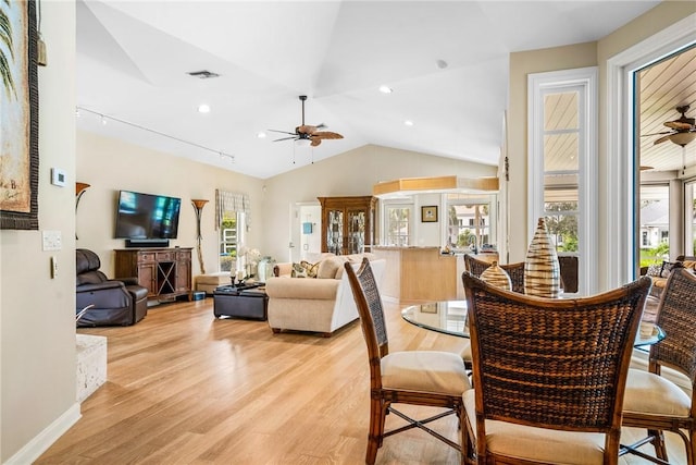 dining space with ceiling fan, light hardwood / wood-style floors, and lofted ceiling