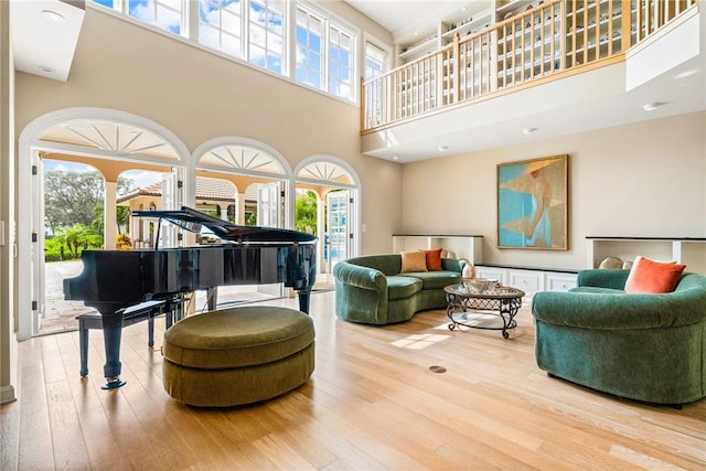 sitting room featuring hardwood / wood-style flooring and a high ceiling