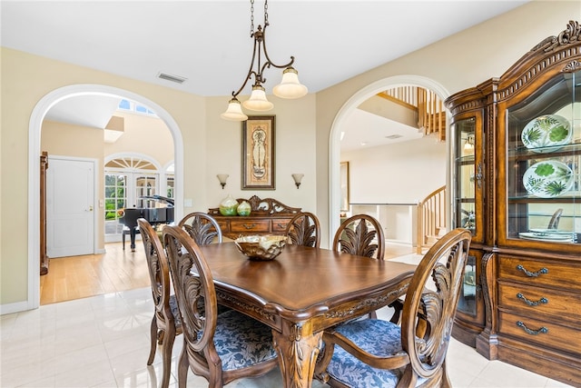 tiled dining area featuring french doors