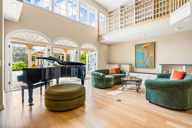 interior space with hardwood / wood-style floors and a high ceiling