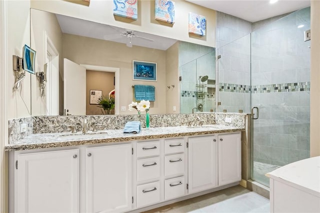 740 Lagoon Rd, Vero Beach, FL 32963 - bathroom with a stall shower, a ceiling fan, double vanity, and tile patterned floors