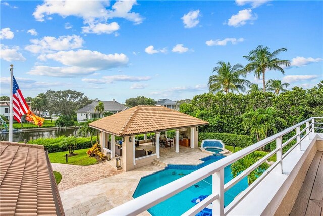 surrounding community featuring a gazebo, a water view, a patio area, and a swimming pool with hot tub