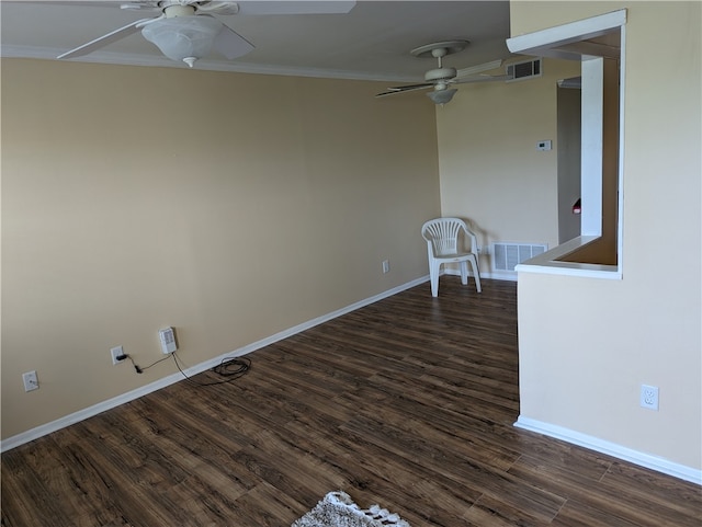 empty room featuring dark wood-type flooring, ceiling fan, and ornamental molding