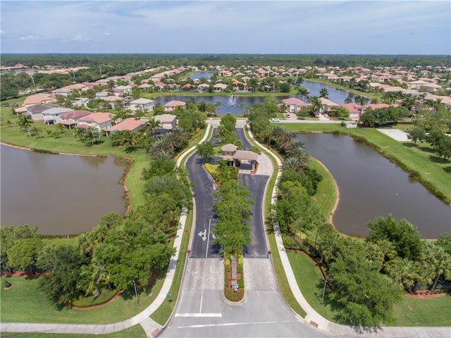 drone / aerial view with a water view and a residential view