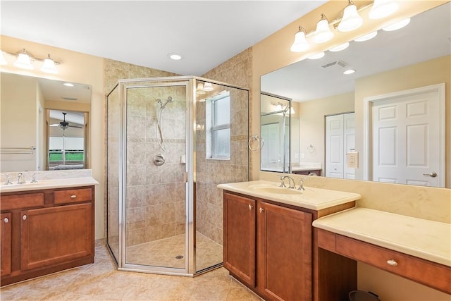 full bath featuring a shower stall, visible vents, two vanities, and a sink