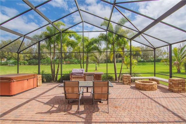 view of patio / terrace with glass enclosure, a hot tub, a fire pit, and outdoor dining area