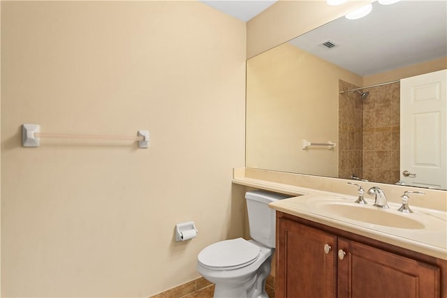 bathroom featuring visible vents, vanity, toilet, and walk in shower