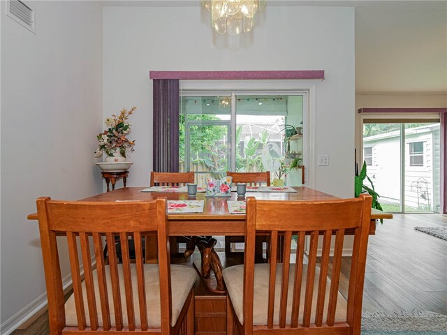 dining room with a chandelier and wood-type flooring