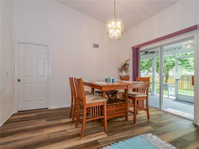 dining area featuring dark hardwood / wood-style floors and an inviting chandelier