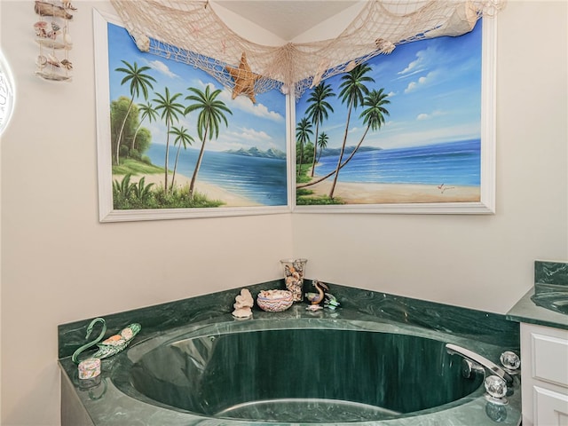 bathroom with vanity and a tub