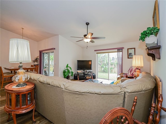 living room featuring hardwood / wood-style flooring, ceiling fan, and lofted ceiling