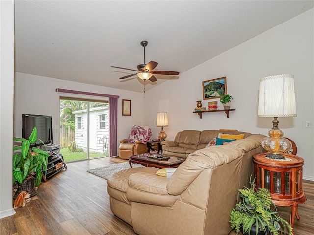 living room with lofted ceiling, hardwood / wood-style flooring, and ceiling fan