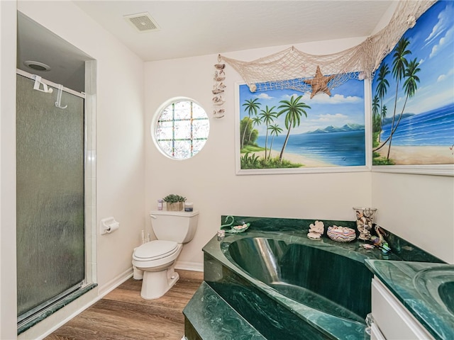 full bathroom featuring shower with separate bathtub, hardwood / wood-style flooring, toilet, and vanity