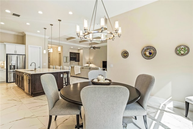 dining room with ceiling fan, crown molding, and sink