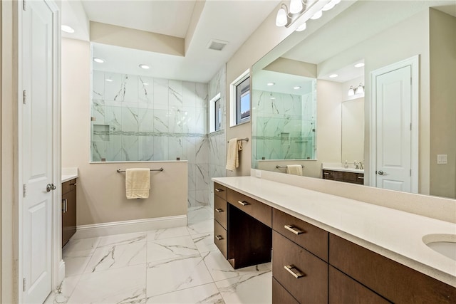 bathroom featuring a tile shower and vanity