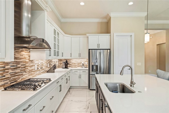 kitchen featuring sink, hanging light fixtures, wall chimney exhaust hood, white cabinetry, and stainless steel appliances