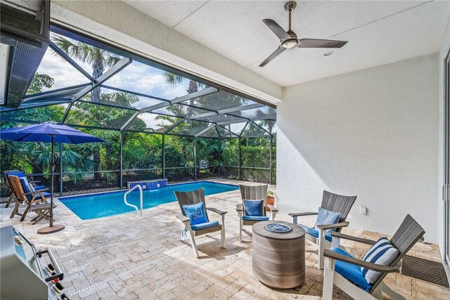 view of pool featuring pool water feature, area for grilling, a lanai, and a patio area