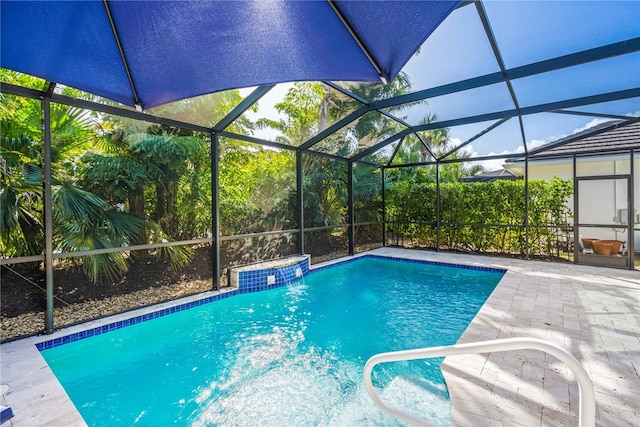 view of pool featuring glass enclosure and a patio