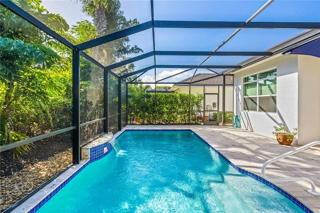 view of pool featuring pool water feature, a patio area, and a lanai