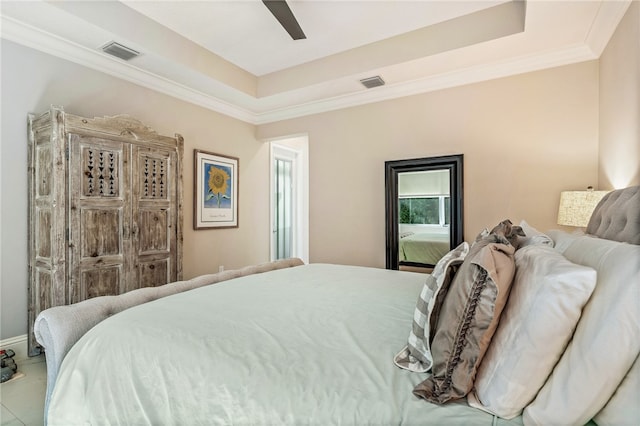 tiled bedroom with ceiling fan, a raised ceiling, and crown molding