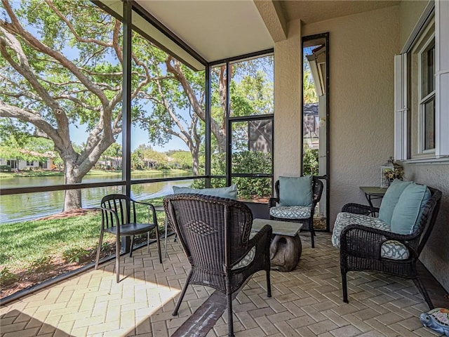 sunroom / solarium with a water view